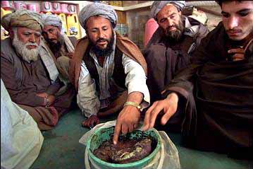 picture of a bucket of raw opium for sale on display at the Kandahar market