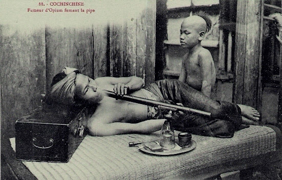 opium smoker and his pipe boy in Indochina